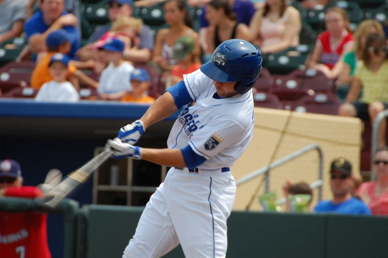 the baseball player is swinging his bat to hit the ball