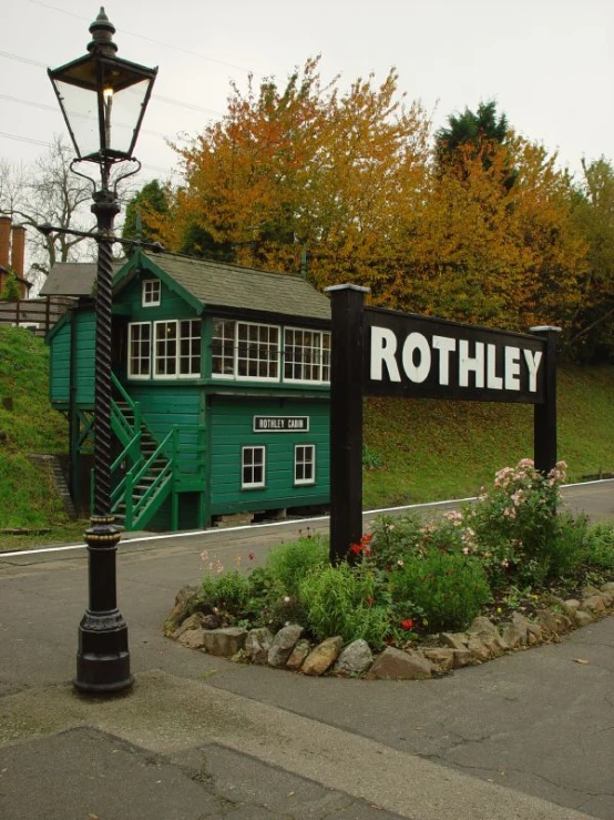 a green building with a sign that says roothley