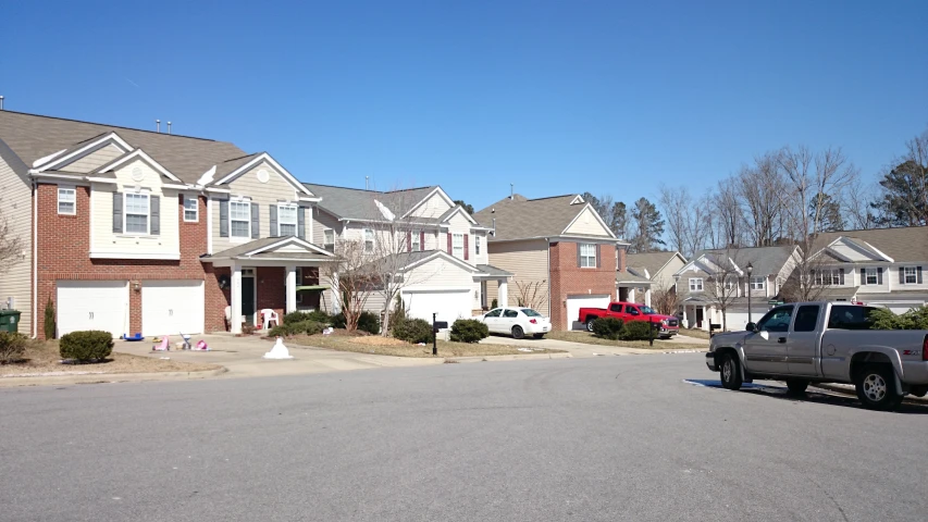 a car is parked in the front yard in the neighborhood