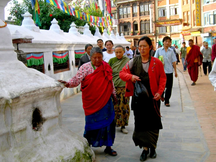 the woman is walking through the busy market