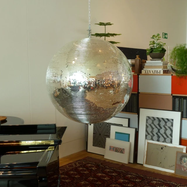 a room with a giant mirror ball hanging from it's ceiling