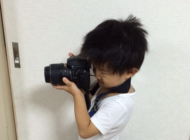 a small child with a camera on the door