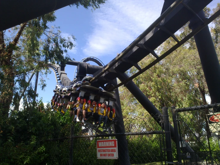 several people are riding the ride on roller coaster