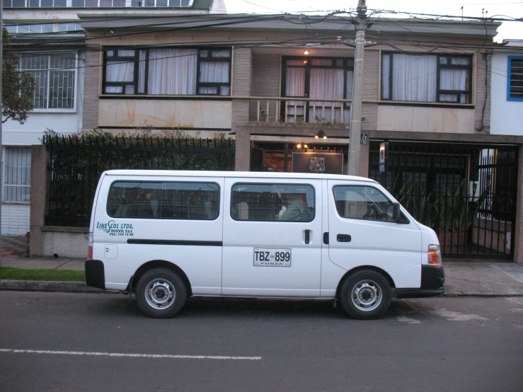 a white van sits in front of some buildings