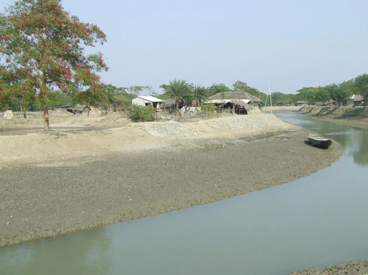 a boat parked at the end of a small river