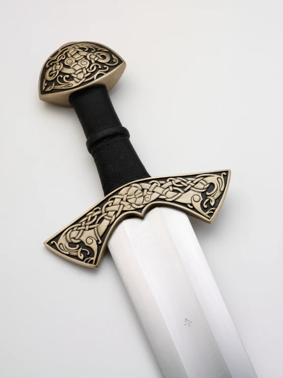 a close up of a sword on a white background