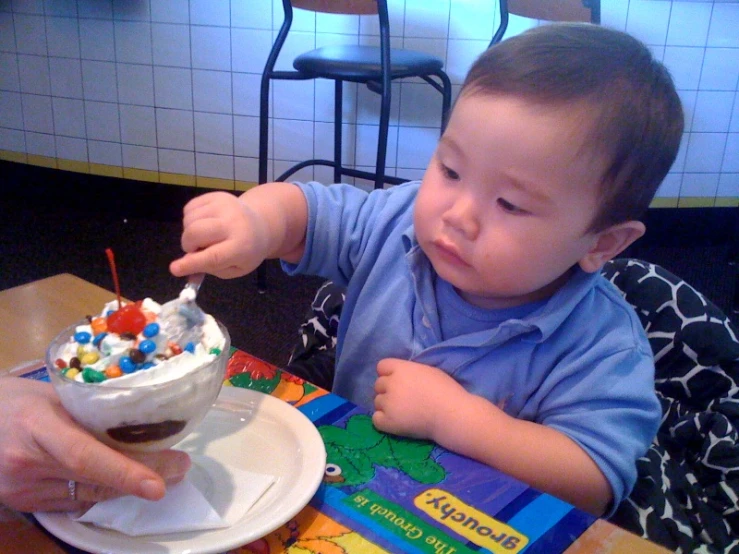 a child has his spoon in a bowl of cereal