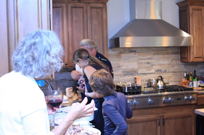 some women are in the kitchen preparing dinner