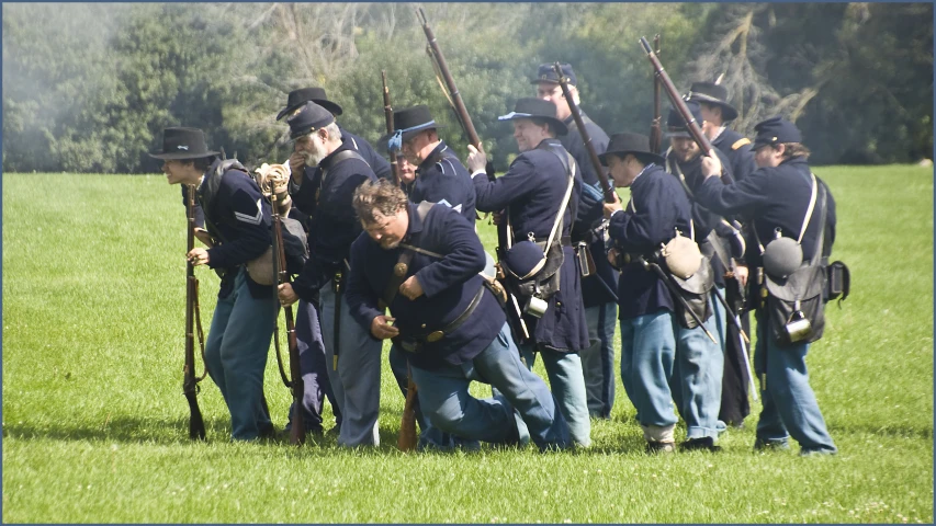 several men wearing blue uniforms standing around each other