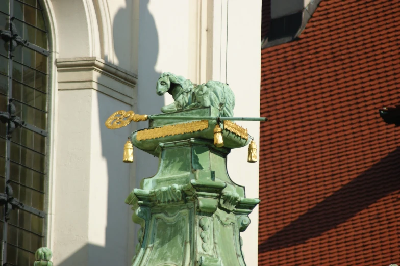 a green building with a clock and a lion on it's side