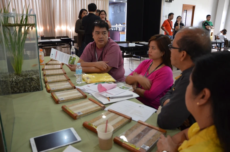 a group of people sitting at a table with notebooks