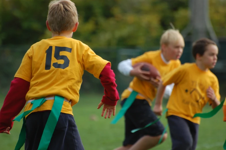 the young children are playing with a disc in a field