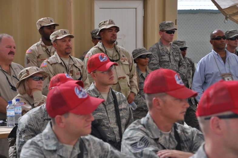 some military men in a group and some sitting