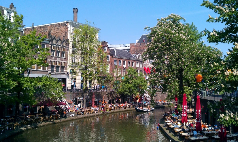 boats traveling down the river past many tall buildings