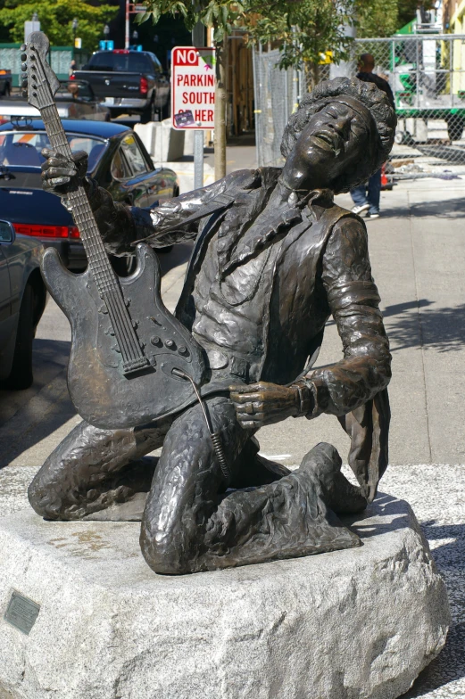 a statue of a man playing a guitar