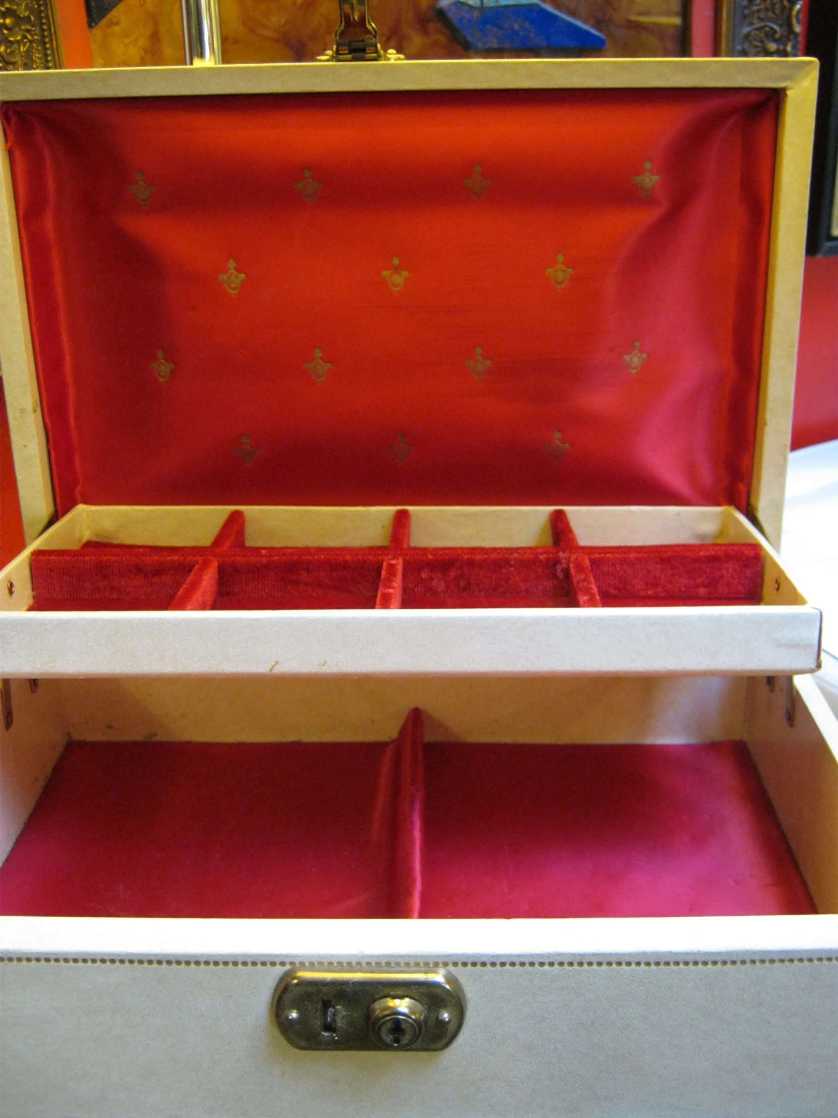 a white storage drawer filled with small, red compartments