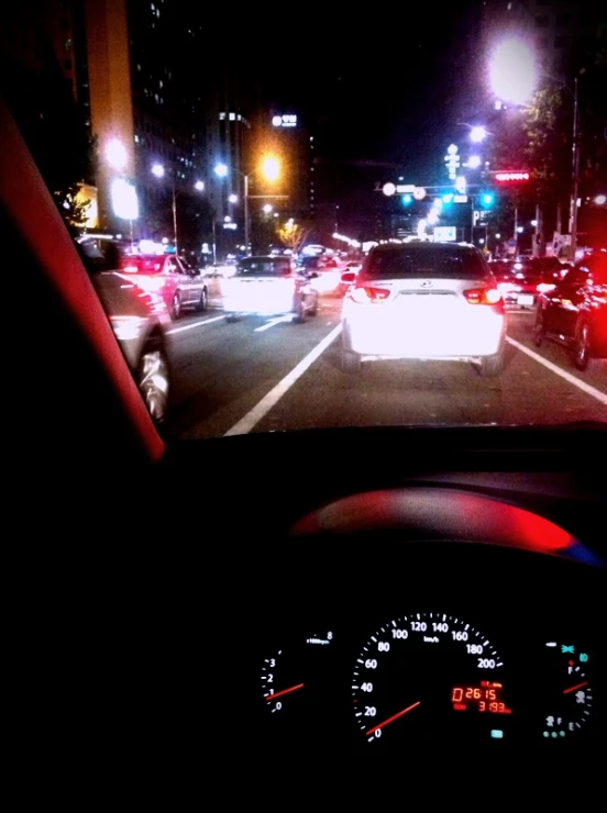 a dashboard s of several cars going down a highway at night