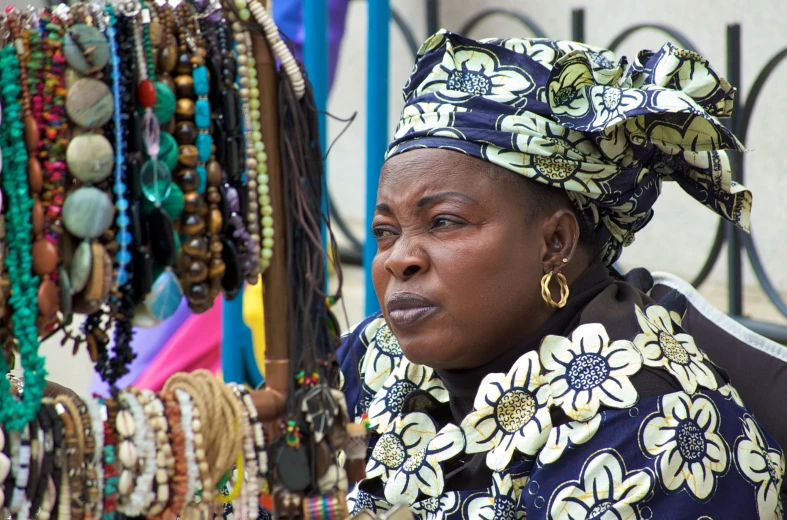 an african woman wearing a necklace and head wrap