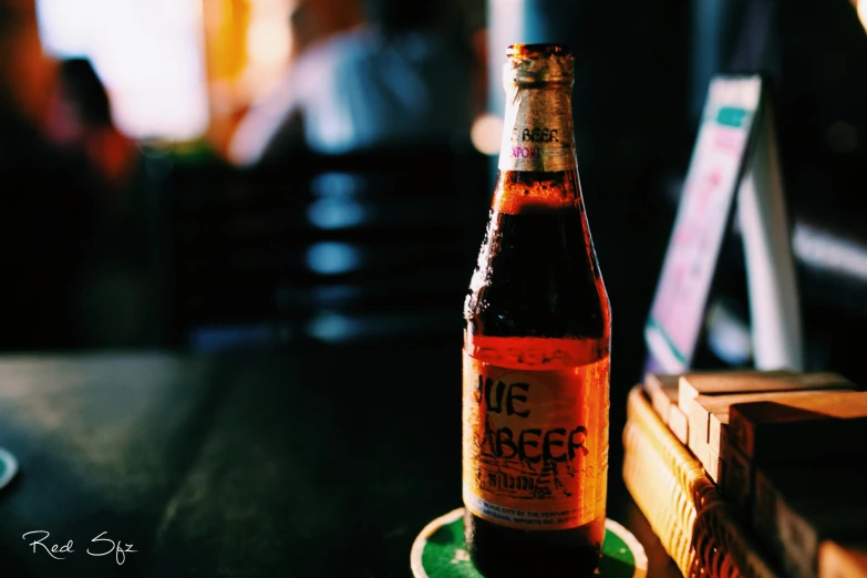 a beer bottle sitting on top of a wooden table