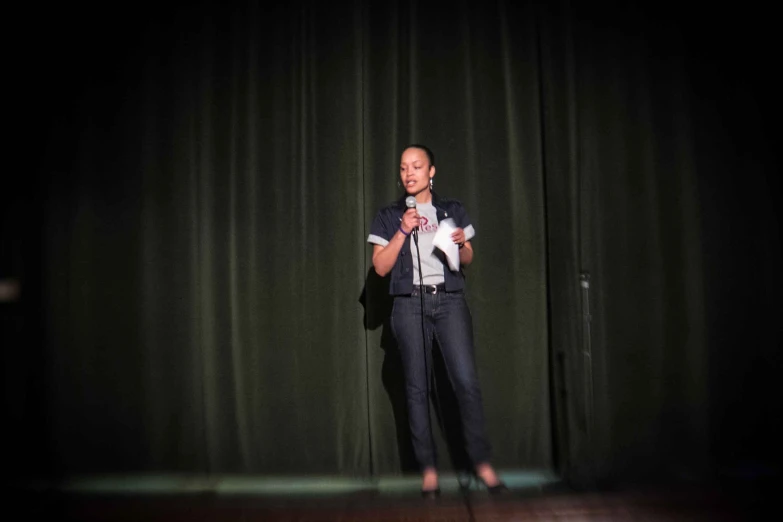 a man on stage speaking with his dog