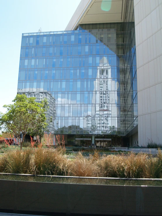 a large building has a reflection of the other buildings