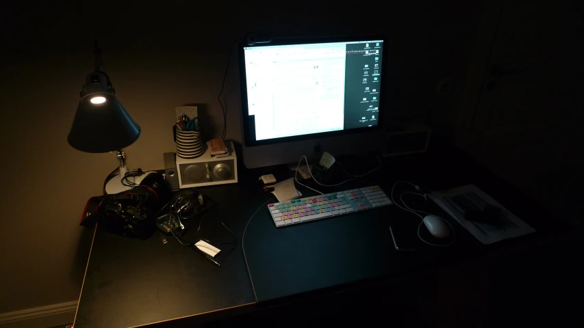 a computer monitor and keyboard sitting on top of a desk