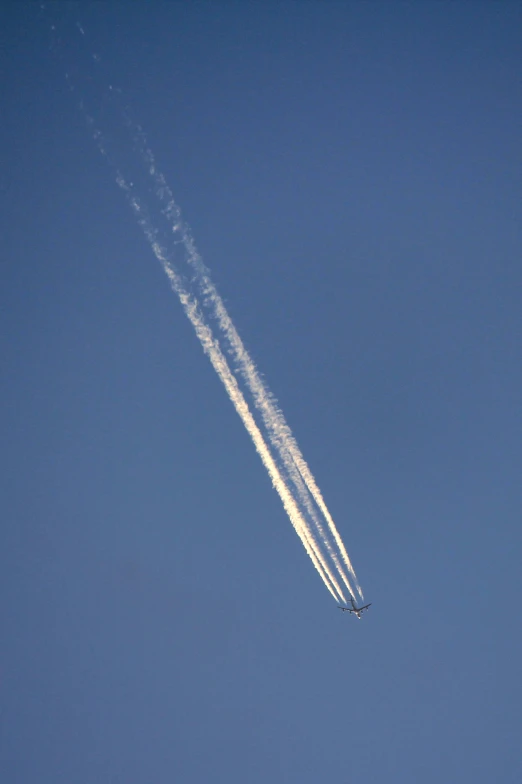 two contrails passing across the clear blue sky