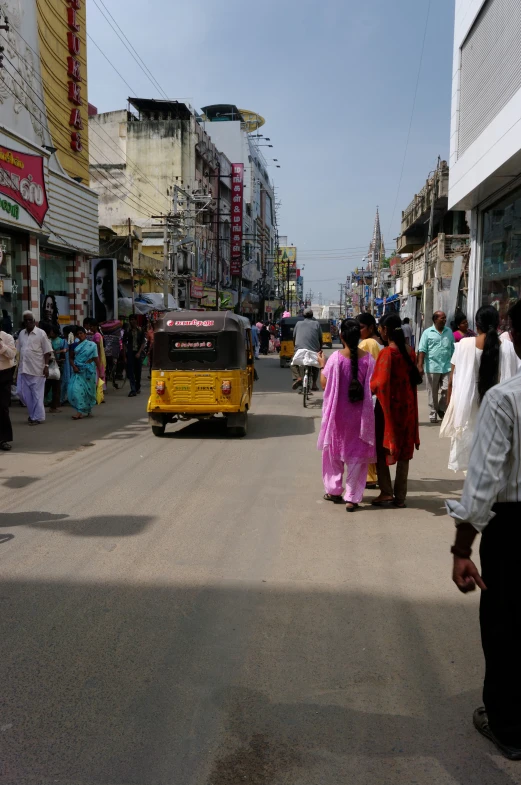 women in pink robes are walking down the street