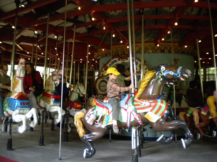 an image of children riding carousels on their horses
