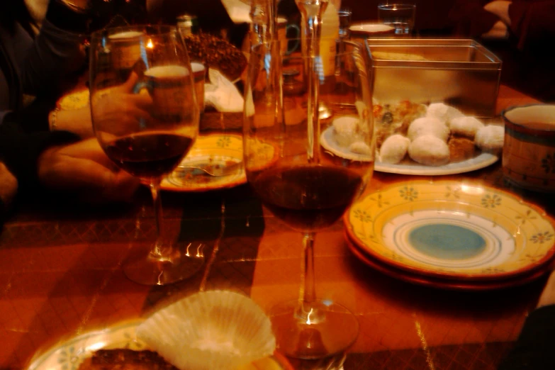 two wine glasses with red wine are on the table