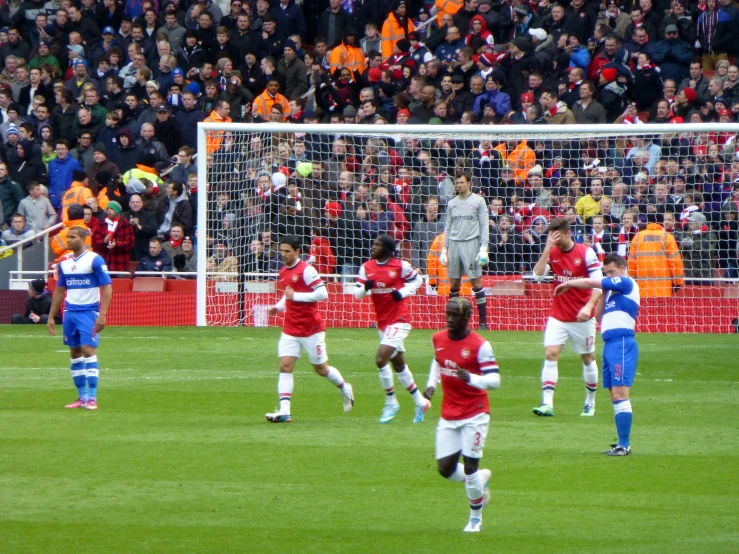 a group of players playing a soccer game