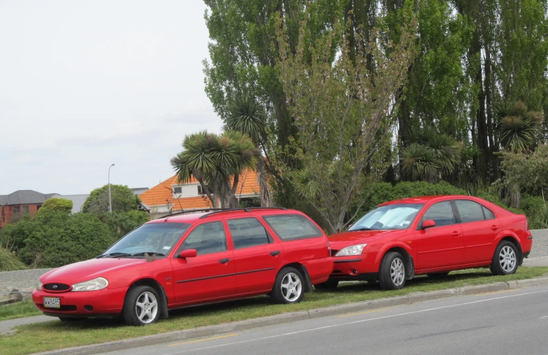 two red cars parked next to each other