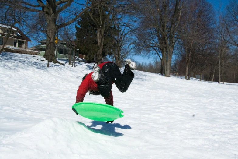 a snowboarder is in the snow doing a trick