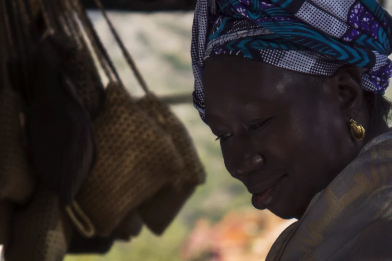 a woman wearing a scarf next to some baskets