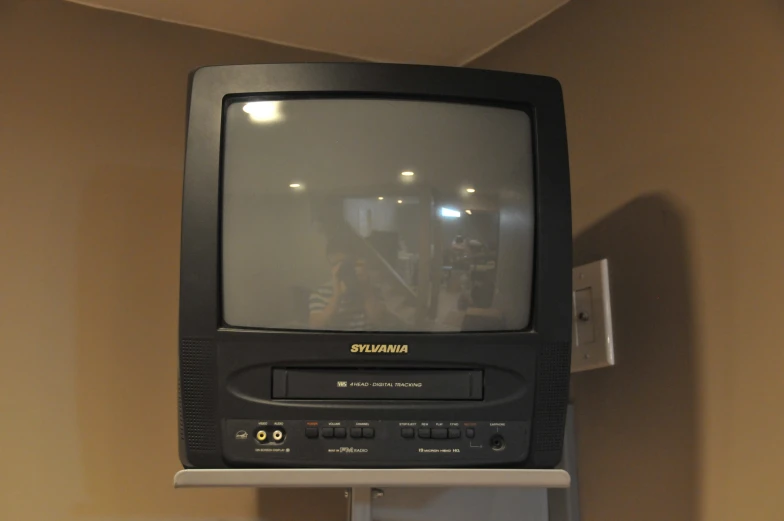 an old tv hanging on the wall in a room