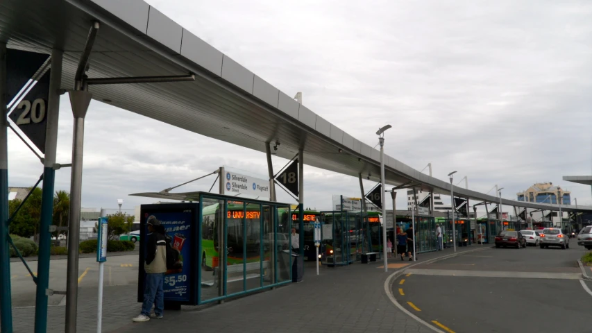 the bus stop has an awning on top of it