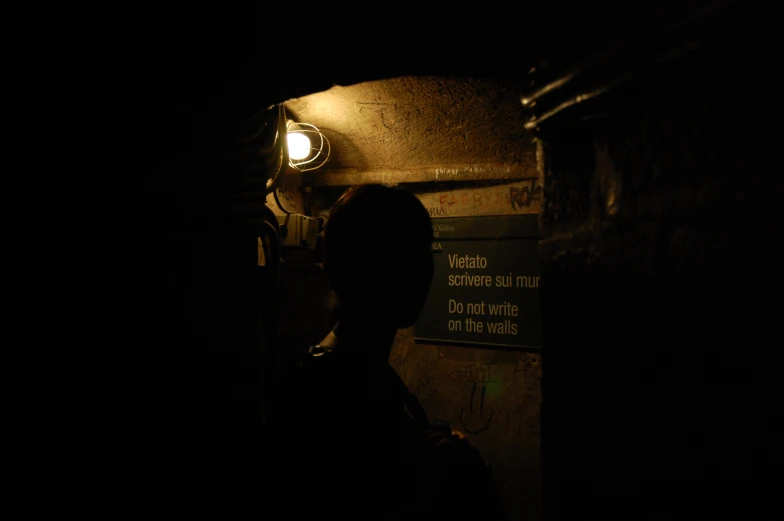 a dark po of a man standing in the dark at night