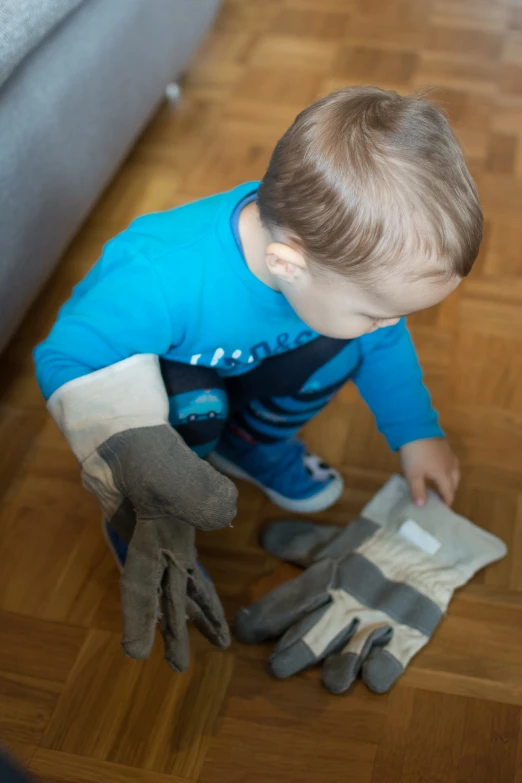 a  is cleaning a floor with rubber gloves