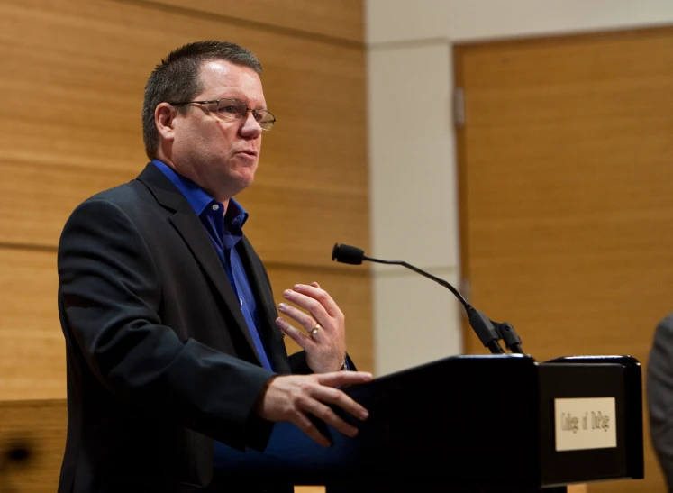 a man giving a speech at an event