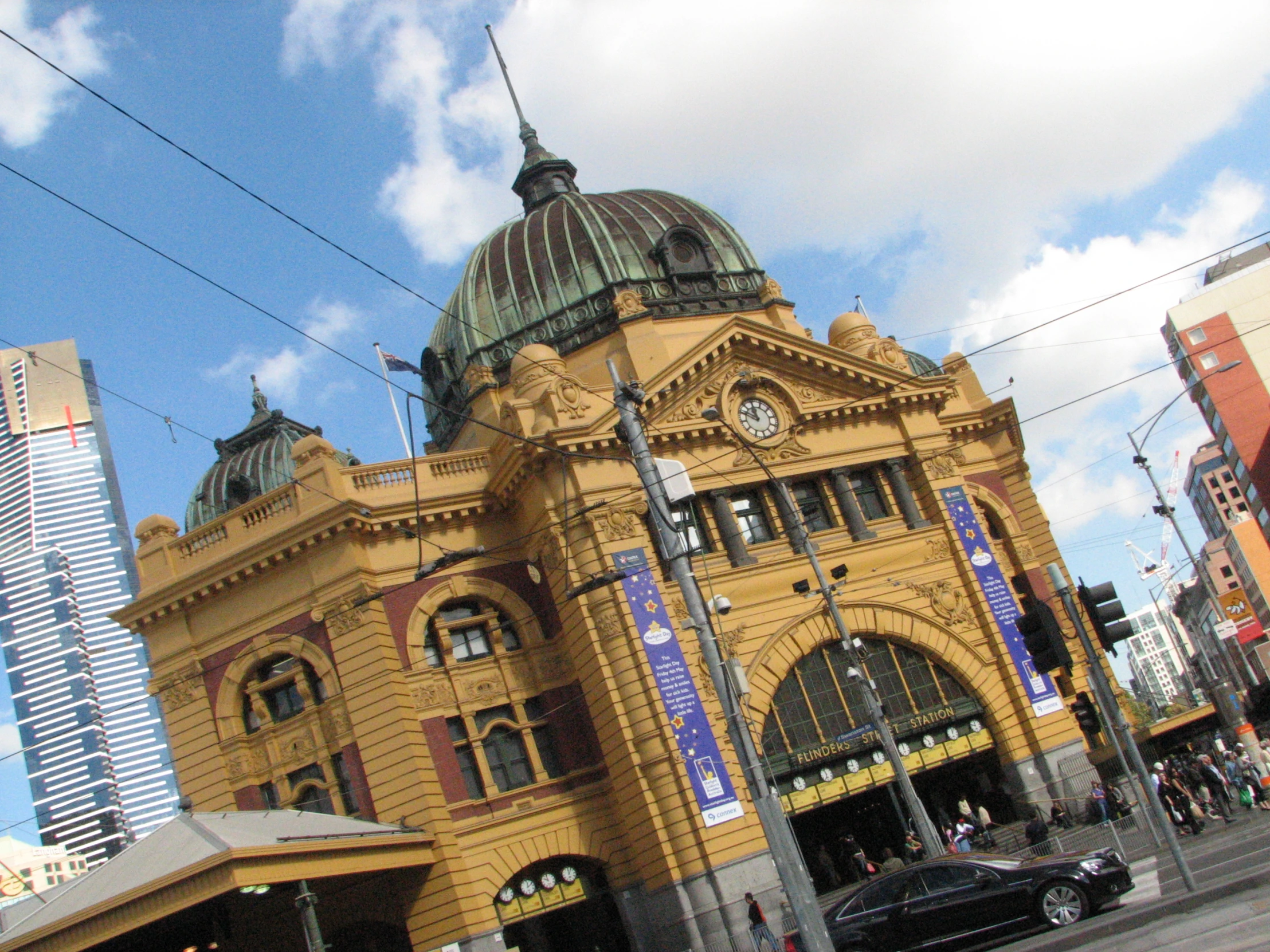 a train station in front of tall buildings