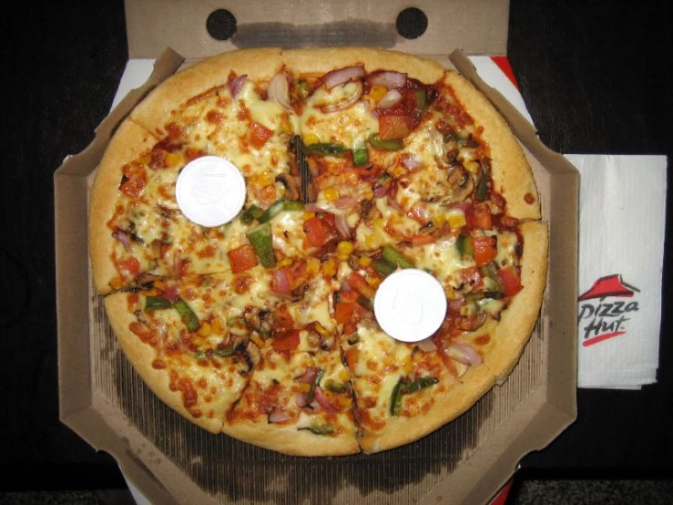 a box holding a large pizza and slices missing