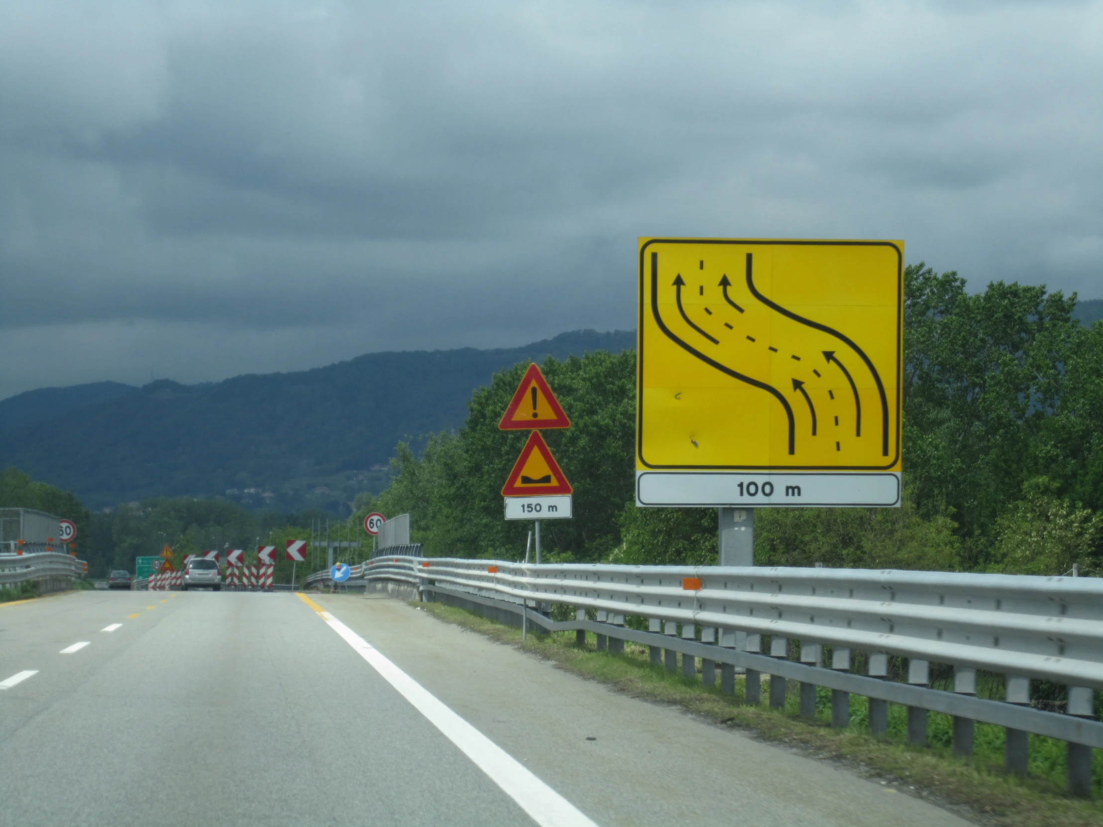 road signs give directions to people who are on the side of the road
