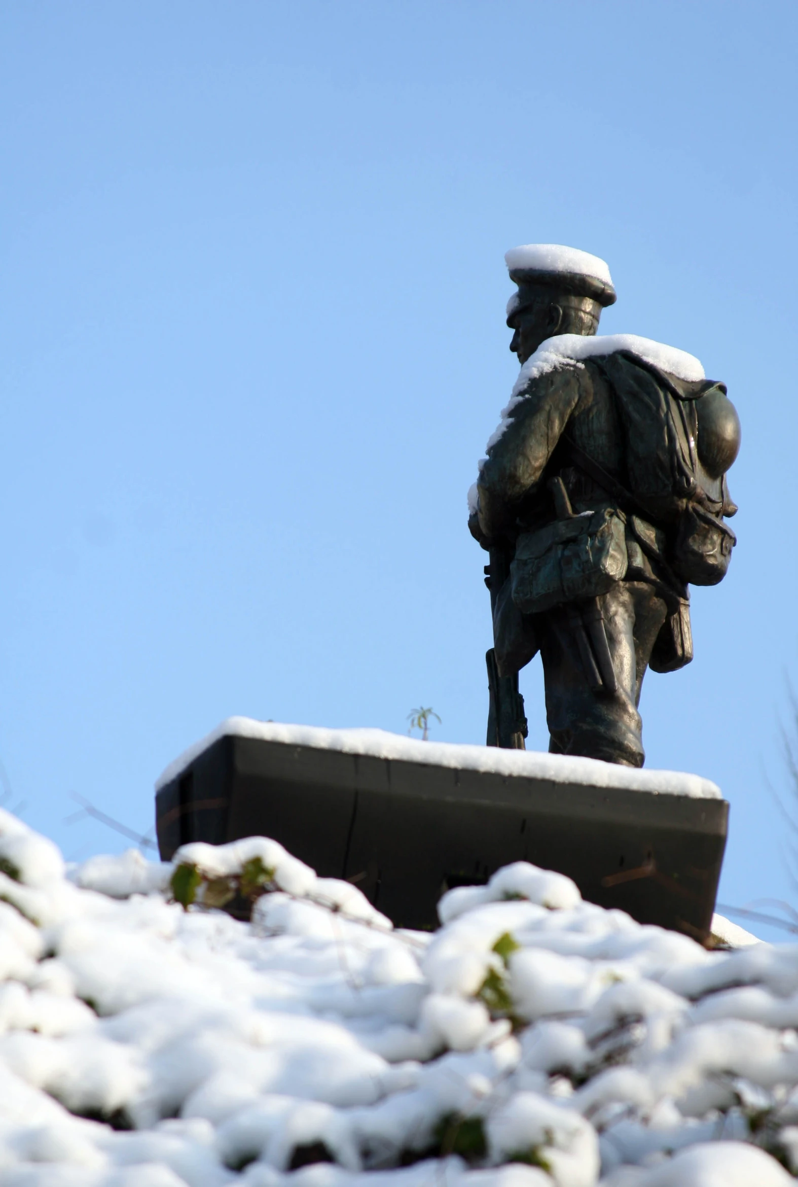 there is a statue on top of the snow covered hill