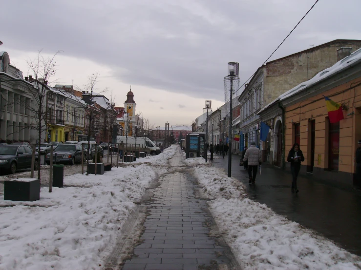 an urban street covered in snow during the day