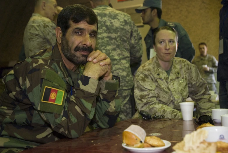 a man sitting at a table with some food