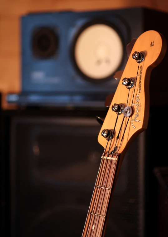 an electric guitar is resting next to a speaker