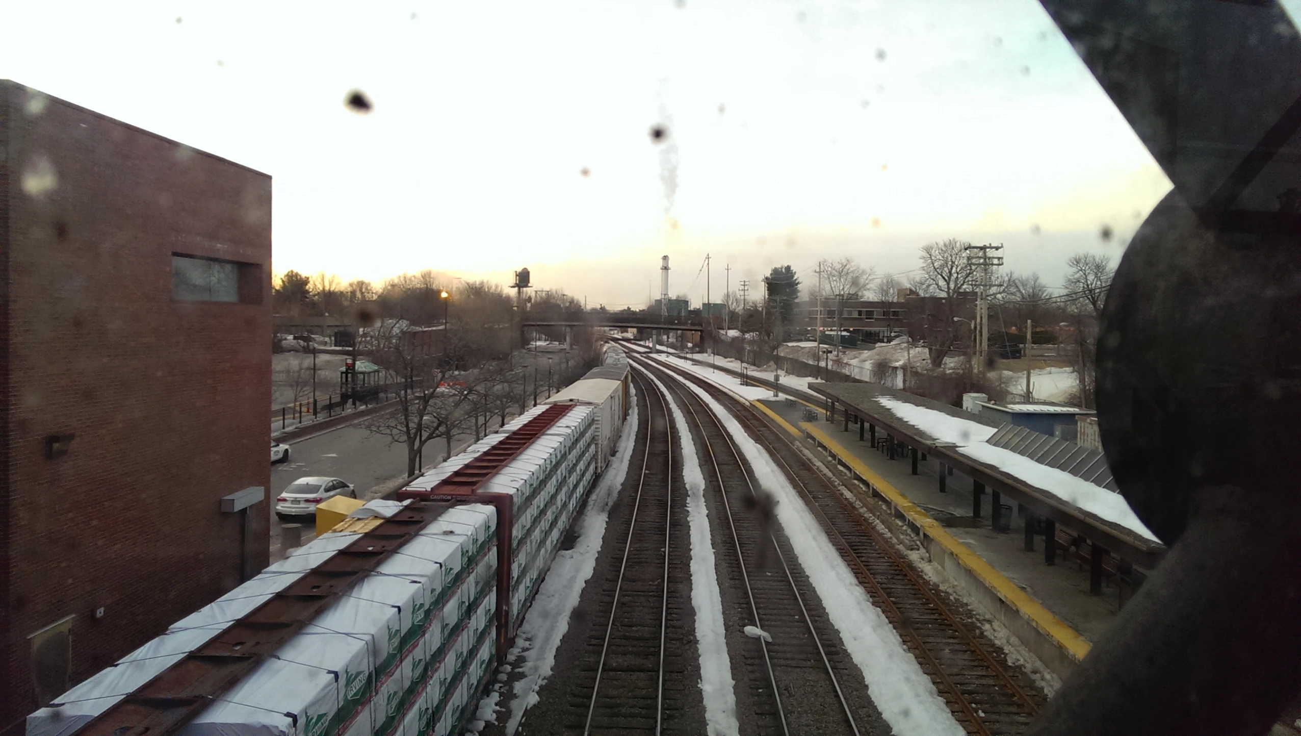 a train is passing under an overcast sky