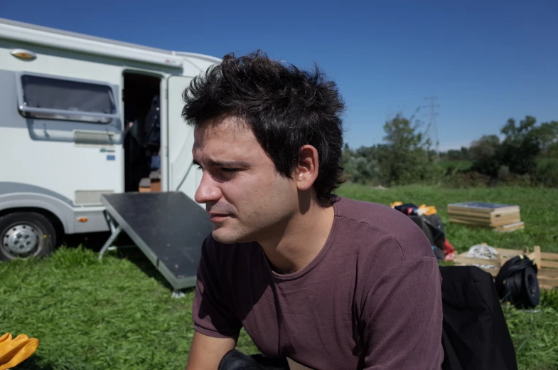 a man in a brown shirt eating a banana