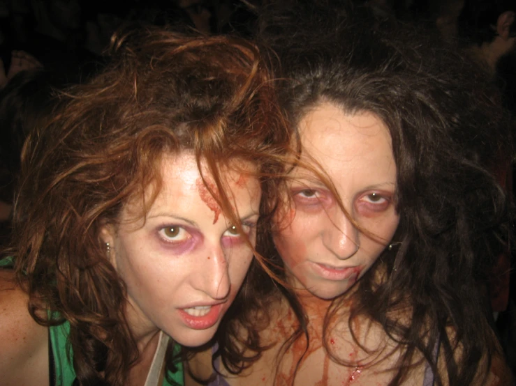 two women, one with pink eye makeup, one with green eyes