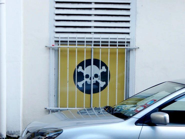 a car parked in front of a gate behind a window